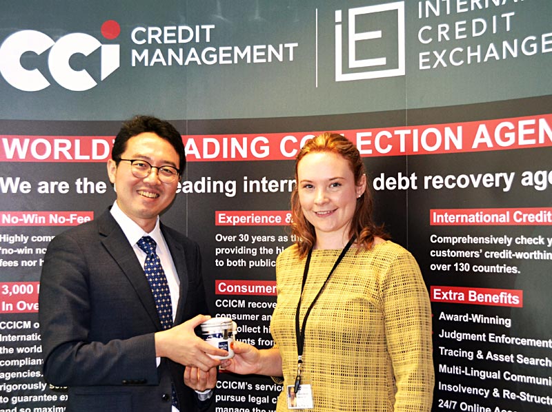 Debt Collection Korea Attorney at Law, Howon Lee, receives a gift of local Welsh salt from ICE Operations Manager Hannah Barratt